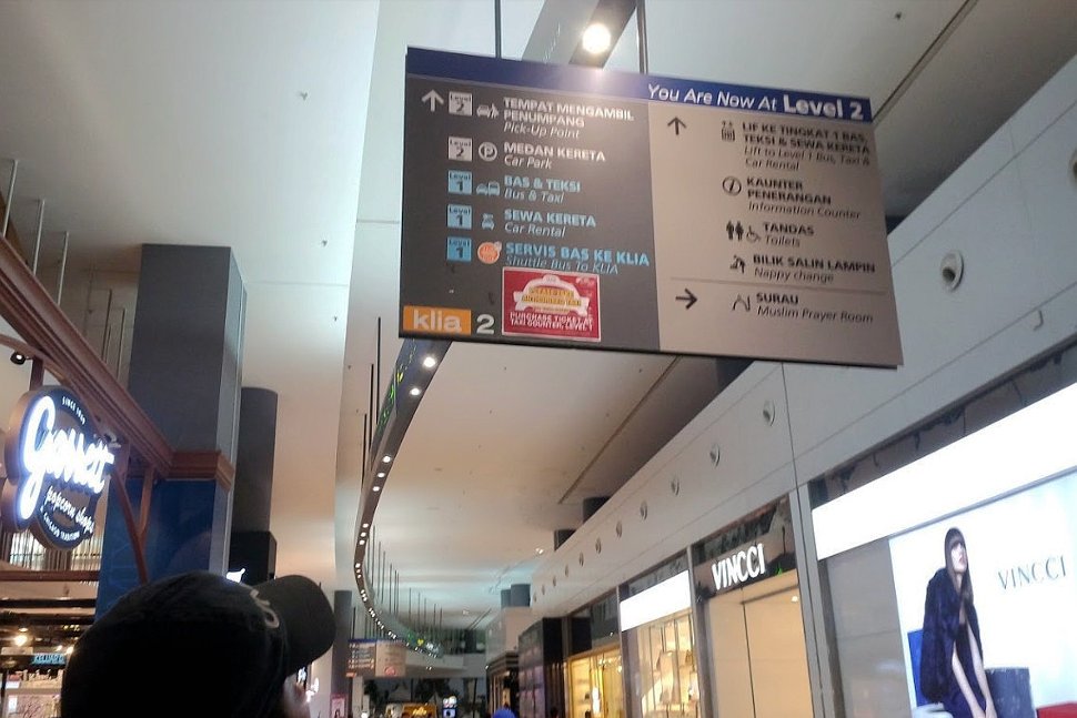 Observe the overhead signboards to go to Transportation Hub at klia2