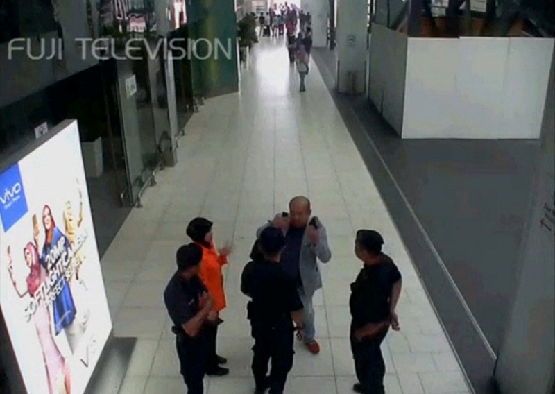 A still image from a CCTV footage appears to show a man purported to be Kim Jong-nam talking to security personnel, after being accosted by a woman in a white shirt, at KLIA2 on February 13, 2017. ?Reuters pic