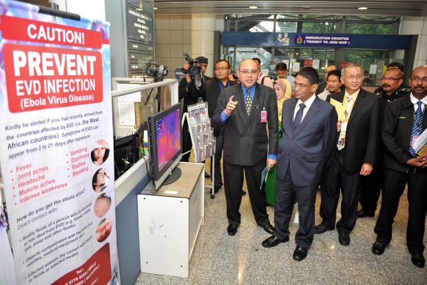 Dr Subramaniam (middle) being briefed of the Ebola screening measures at KLIA