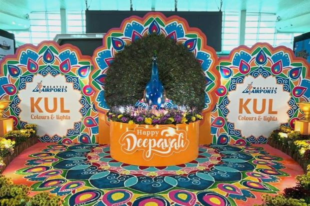 A peacock sits in the centre of a colourful kolam at one of the spots in KLIA decorated to welcome Deepavali