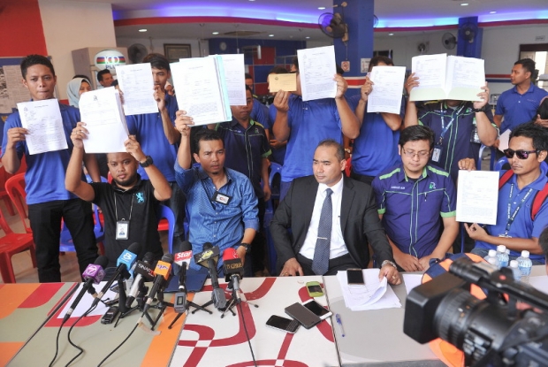 Rayani Air’s klia2 station manager, Zulkalnain Azdan (seated second left) and other staff hold a press conference on the issue of salary arrears, in Bandar Baru Salak Tinggi, April 22, 2016. Also present is Zaflee Pakwanteh, the lawyer representing the workers involved. — Bernama pic