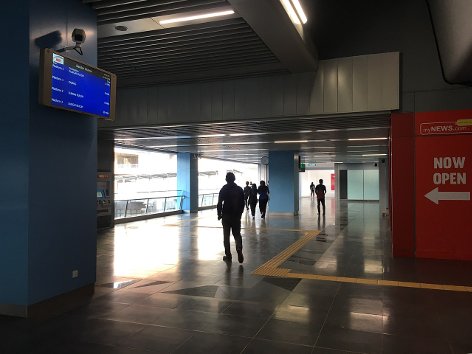 Commuters headed towards Entrance B of the station