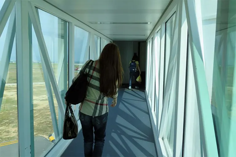 Passengers walking on the Aerobridge to the connected Pier