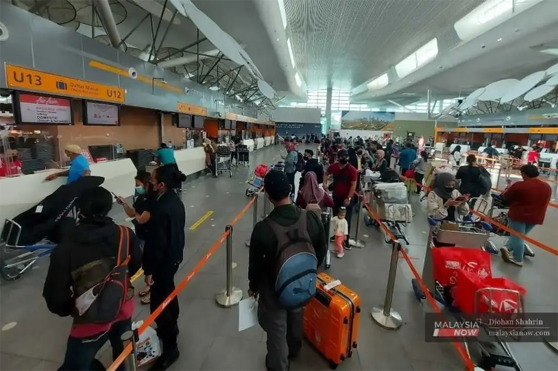 Passengers queue at the ticket counter at klia2 in Sepang