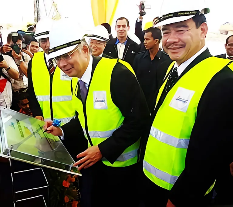 Najib signing a plaque at the ceremony in Sepang