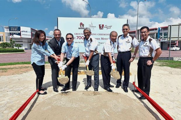 Mohamed Azahari (third from left), Mohamd Haslah (centre) and Lee (third from right) performing the ground-breaking ceremony for the new KFC outlet at Sendayan Metro Park