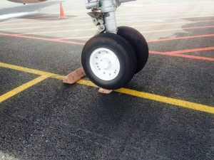 Plane tyre over the safety chock in klia2. The Malaysian Insider pic, May 20, 2014.