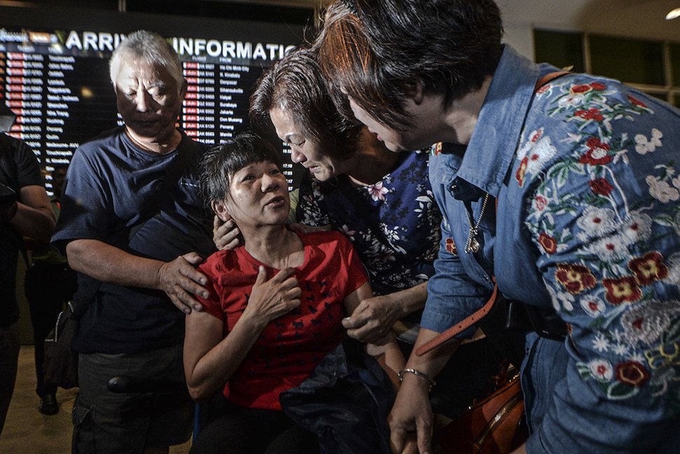 Malaysian victim of the Lombok earthquake, How Geok Lan (in red), is greeted by her former schoolmates of the same batch born in 1963 after arriving at klia2 in Sepang March 19, 2019. — Picture by Shafwan Zaidon