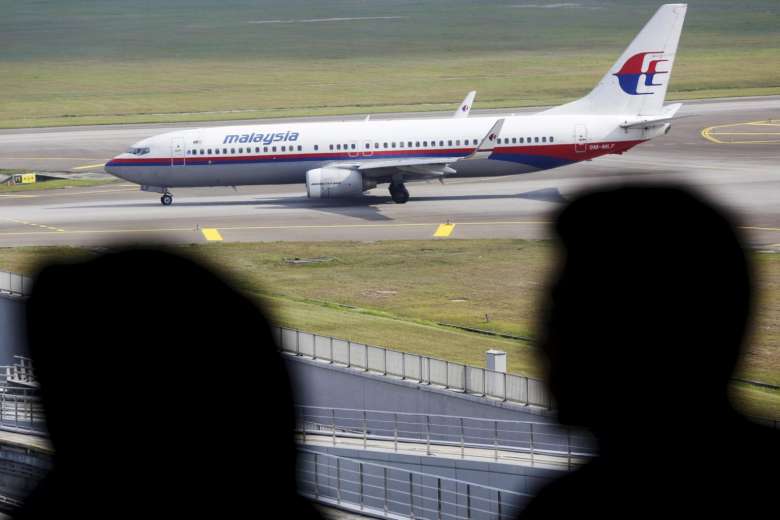 Men watch Malaysia Airlines aircraft at Kuala Lumpur International Airport in Sepang, Malaysia, in this picture taken on March 2.
