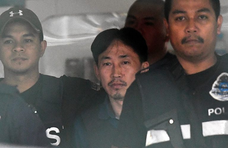 Ri Jong-chol is accompanied by a heavily armed escort while wearing a bulletproof vest as he makes his way out of the Sepang IPD during his deportation on March 3, 2017. Bernama Photo