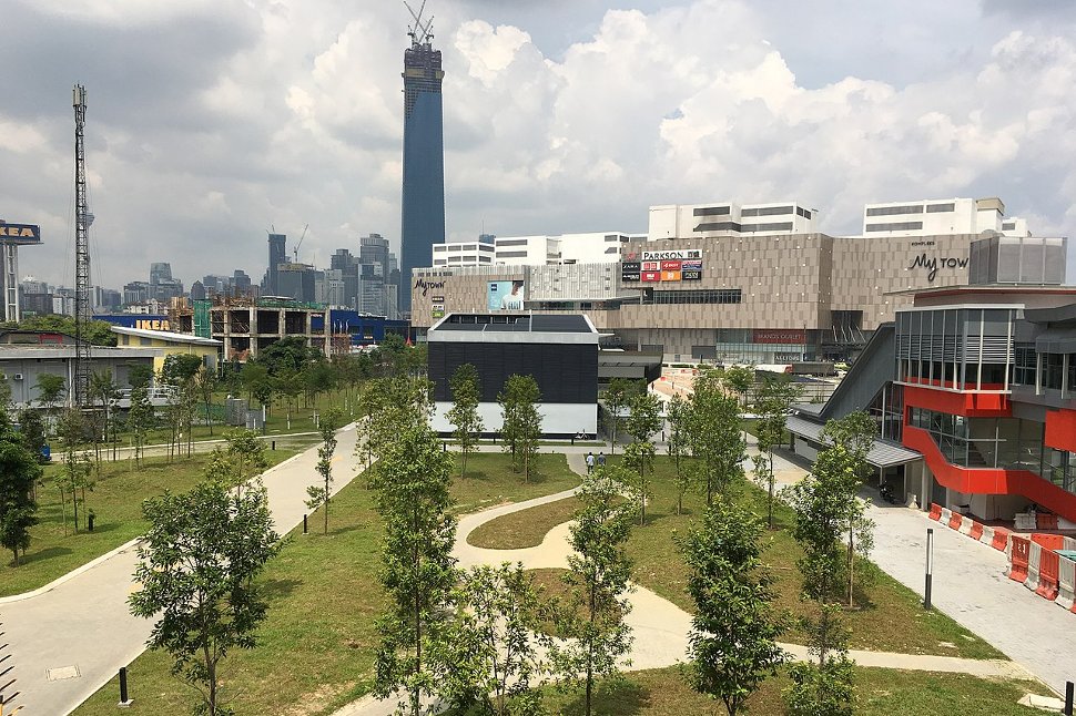 Landscaping at the ground level of the station. Entrance B to the station is the black building at centre.