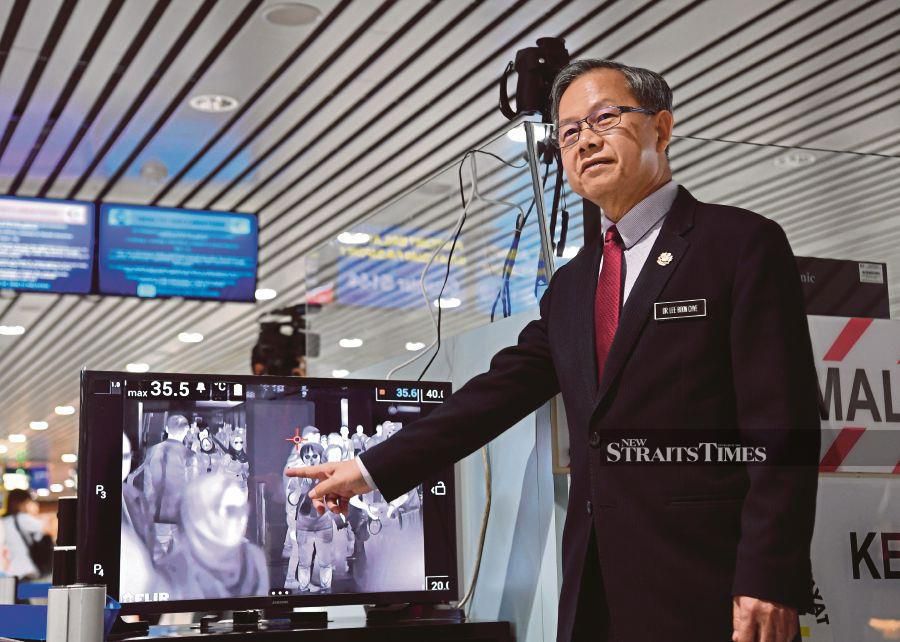 Deputy Health Minister Dr Lee Boon Chye showing a thermal scanner to screen travellers at the Kuala Lumpur International Airport, Sepang, yesterday. - Bernama