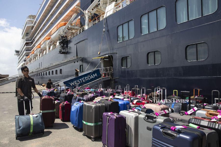 Cruise passengers luggage gets unloaded from the MS Westerdam cruise ship after being stranded for two weeks, now docked on February 14, 2020 in Sihanoukville, Cambodia. The ship is completely free from the Coronavirus (COVID-19.) but was turned away from five other Asian ports, it departed Hong Kong February 1st with 1,455 passengers and 802 crew on board. Another cruise ship is in quarantine in Japan with more than 200 infections. The Coronavirus cases rise to more than 64,000 people, total number of deaths is approximately 1,383. (Photo by Paula Bronstein/Getty Images/ Bloomberg)