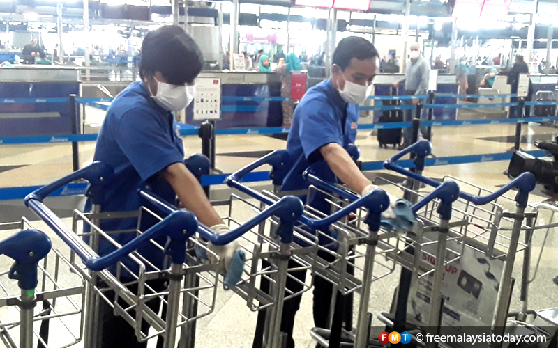 Members of KLIA’s cleaning crew sanitising trolleys during a media tour today.