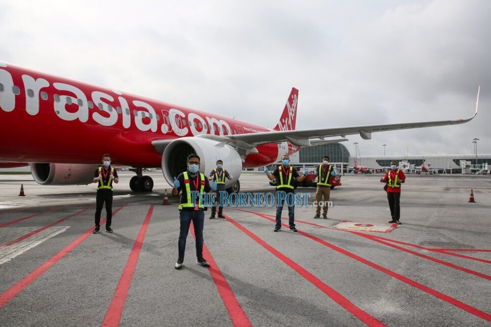AirAsia Malaysia resumed its domestic flight operations today after a one-month hibernation. Seen here is AirAsia Malaysia chief executive officer Riad Asmat (second left), who was at the scene to ensure smooth operations.