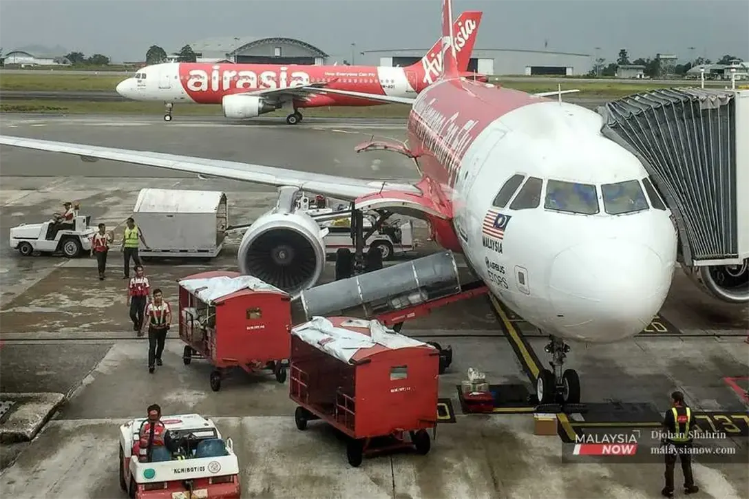 AirAsia planes sit on the tarmac