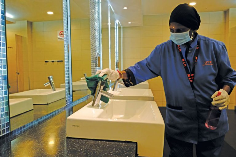 A cleaning operative conducting her regular sanitisation work