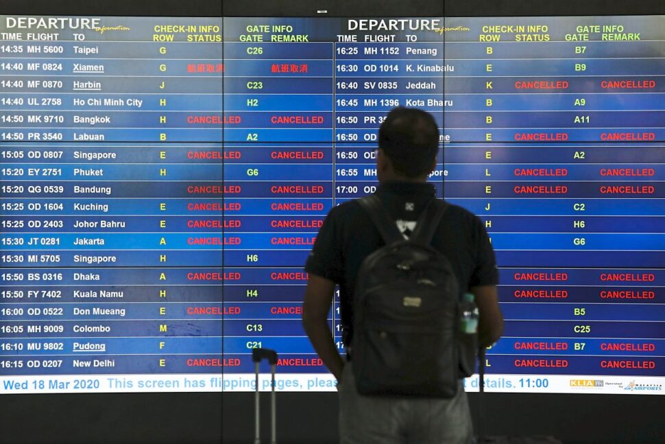An information board at KLIA displaying cancelled flights after the Malaysian government closed its borders on March 18. — LIM HUEY TENG/Reuters