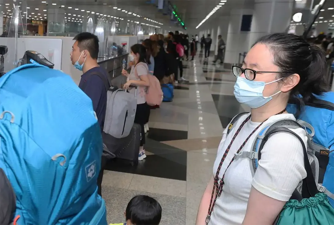 Travellers from China queue at the arrival hall of KLIA in Sepang today. Photo: Bernama