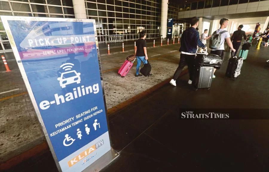 The new designated pick-up points for e-hailing services at the Kuala Lumpur International Airport in Sepang are now at Doors 3 and 4, Level 1 of the Main Terminal Building. PIC BY INTAN NUR ELLIANA ZAKARIA