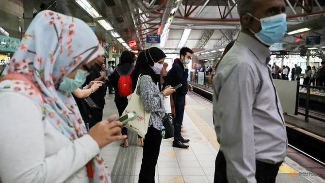Passengers wear protective masks while they wait for Light Rail Transit train at a station, following the outbreak of the new coronavirus in China, in Kuala Lumpur, Malaysia. (REUTERS/Lim Huey Teng/File Photo)