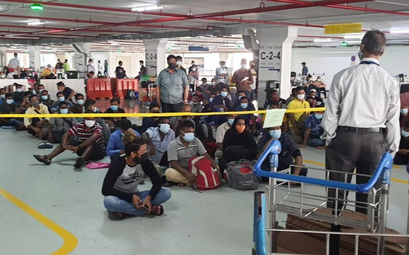 Many migrants were forced to wait at the KLIA car park with no fans to keep them cool in the hot weather.