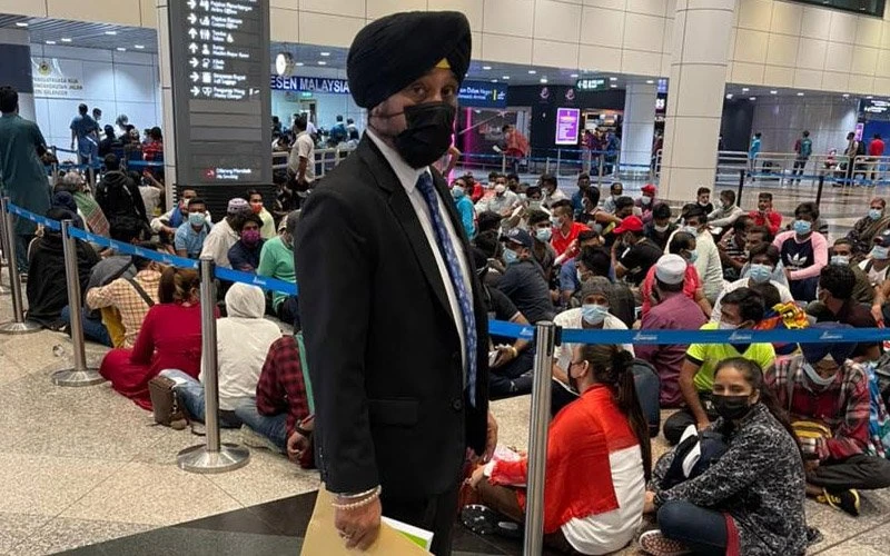 Harpal Singh with migrants waiting to be processed at KLIA.