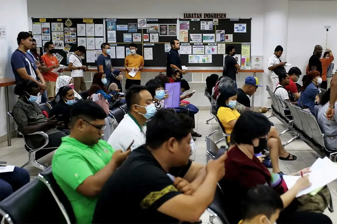 People wait for their turn at an immigration department counter in Seremban, Jan 31. Photo: Bernama