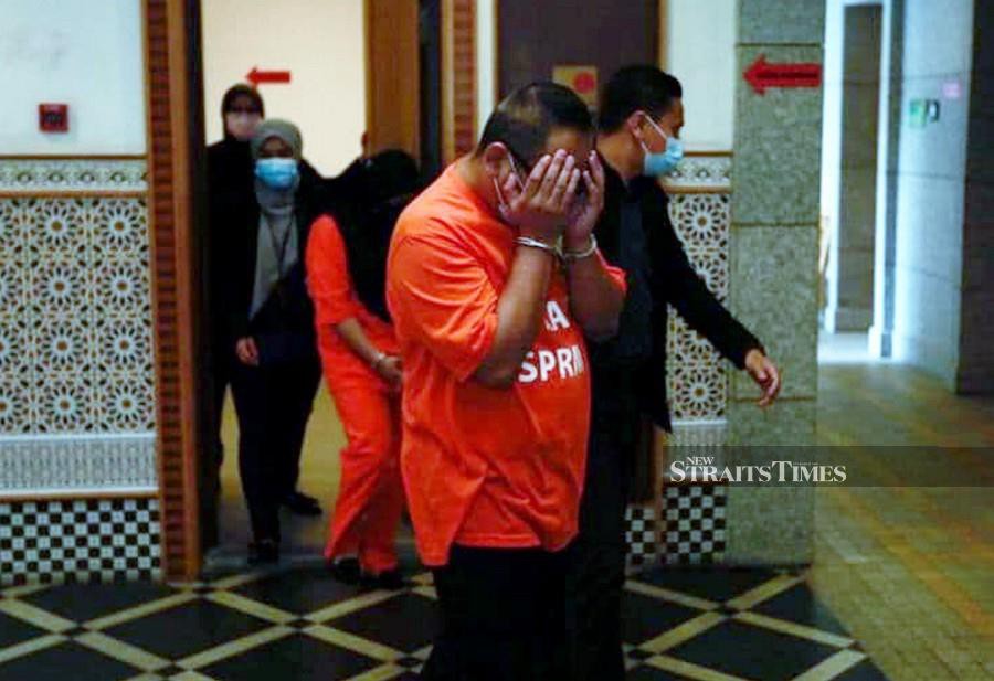 This Nov 27 pic shows three Immigration Dept officers being led by MACC officers at the Putrajaya Courts Complex.