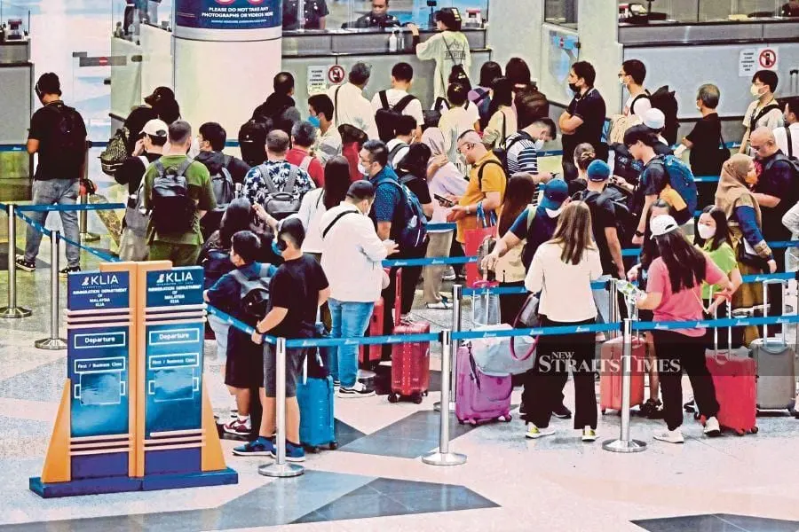 Foreign tourists at the Immigration Department, Kuala Lumpur International Airport (KLIA). - NSTP/AIZUDDIN SAAD