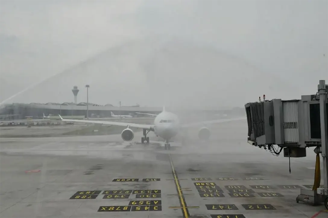 Malaysia Airports Holdings Bhd fire department bowsers spraying water jets on the arriving Malaysia Airlines flight that arrived direct from Doha, Qatar at the Kuala Lumpur International Airport in Sepang.