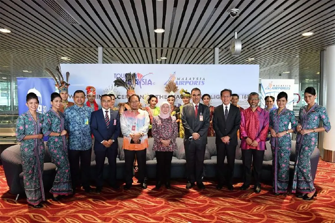 Datuk Seri Nancy Shukri (centre) with Malaysia Airlines cabin crew and officials receive the first batch of tourists who flew direct from Doha, Qatar at the Kuala Lumpur International Airport in Sepang.