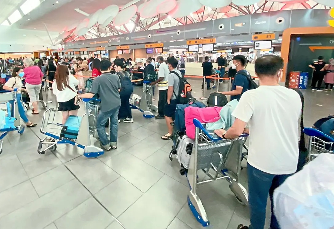 Off we go: Travellers waiting before checking in at KLIA2 en route to their destinations in the first week of the long school holidays. — RAJA FAISAL HISHAN/The Star
