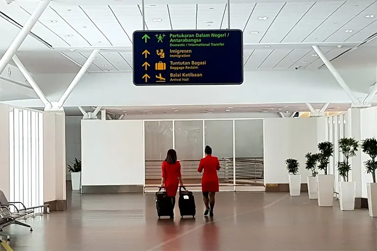 Observe the overhead signboard for Flight Transfer direction