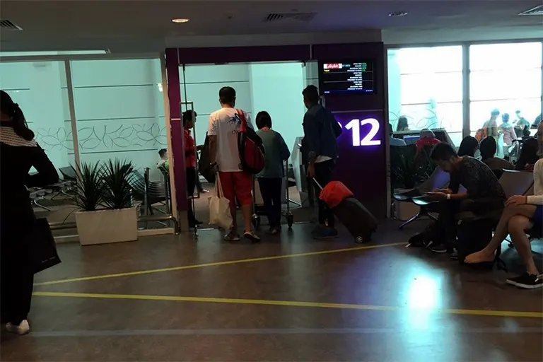 Passengers entering the waiting area