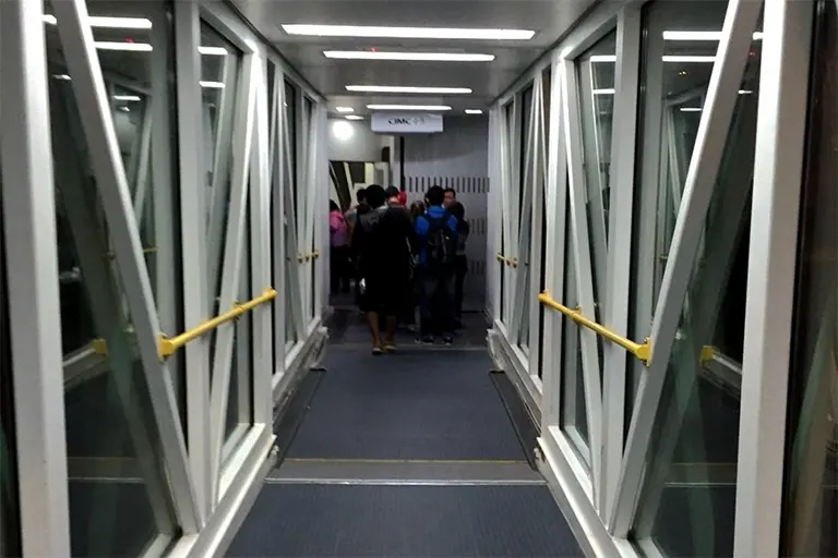 Passengers walking on the Aerobridge and boarding the flight