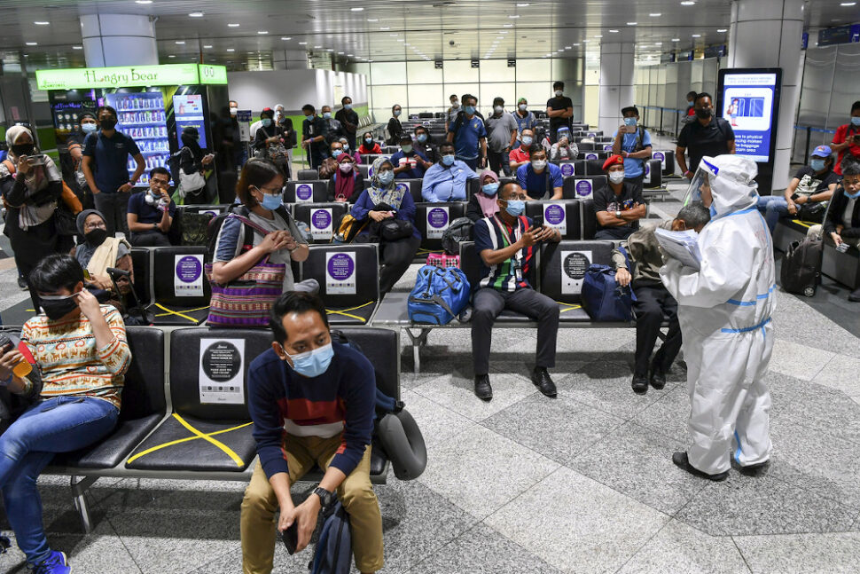 Health Ministry officers briefing passengers from Sabah upon their arrival at the Kuala Lumpur International Airport (KLIA) September 28, 2020. — Bernama pic
