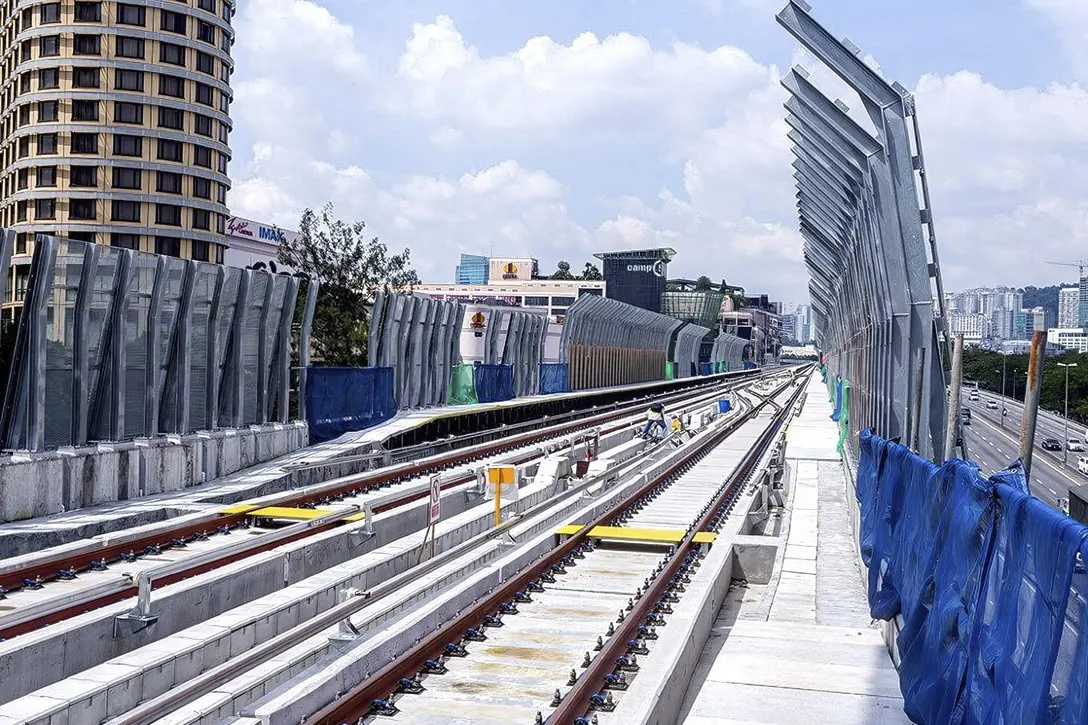 View of the completed MRT guideway with tracks and noise barriers near the Bandar Utama Station.