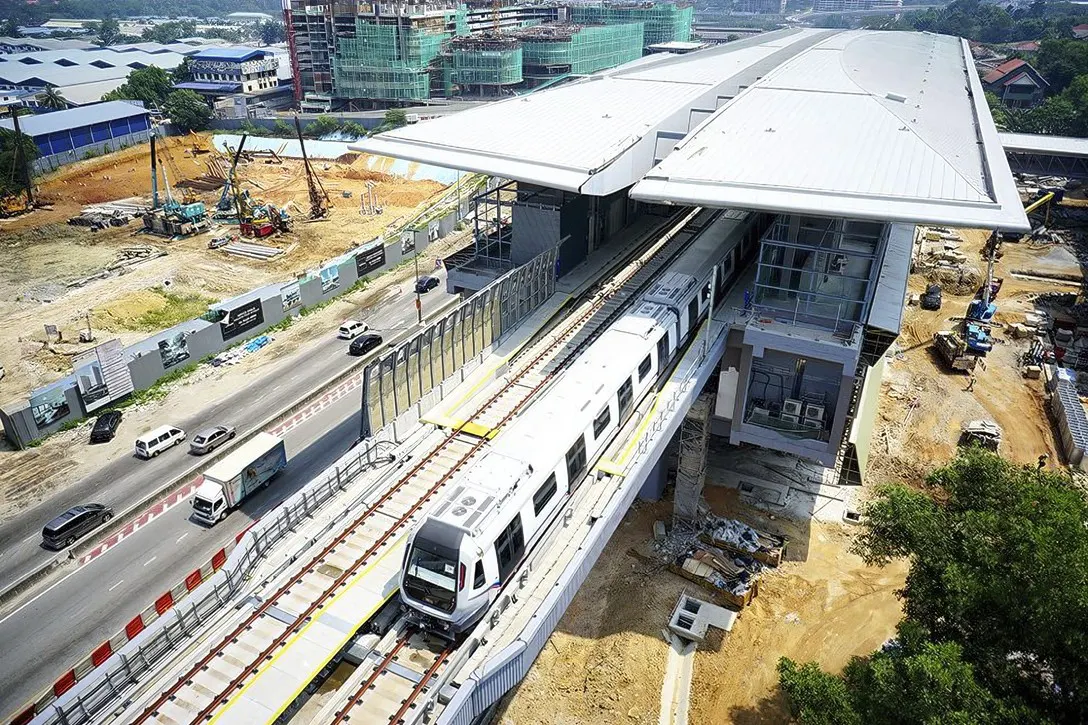 Aerial view of the trains undergoing testing on the completed guideway leaving the Kampung Selamat station