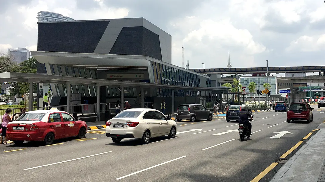 Pasar Seni MRT Station entrances (left) and the LRT station (back) along Jalan Sultan