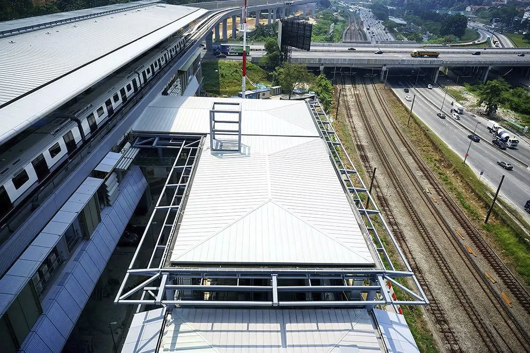 View of the Sungai Buloh MRT Station (left) located next to the KTM train tracks (right).