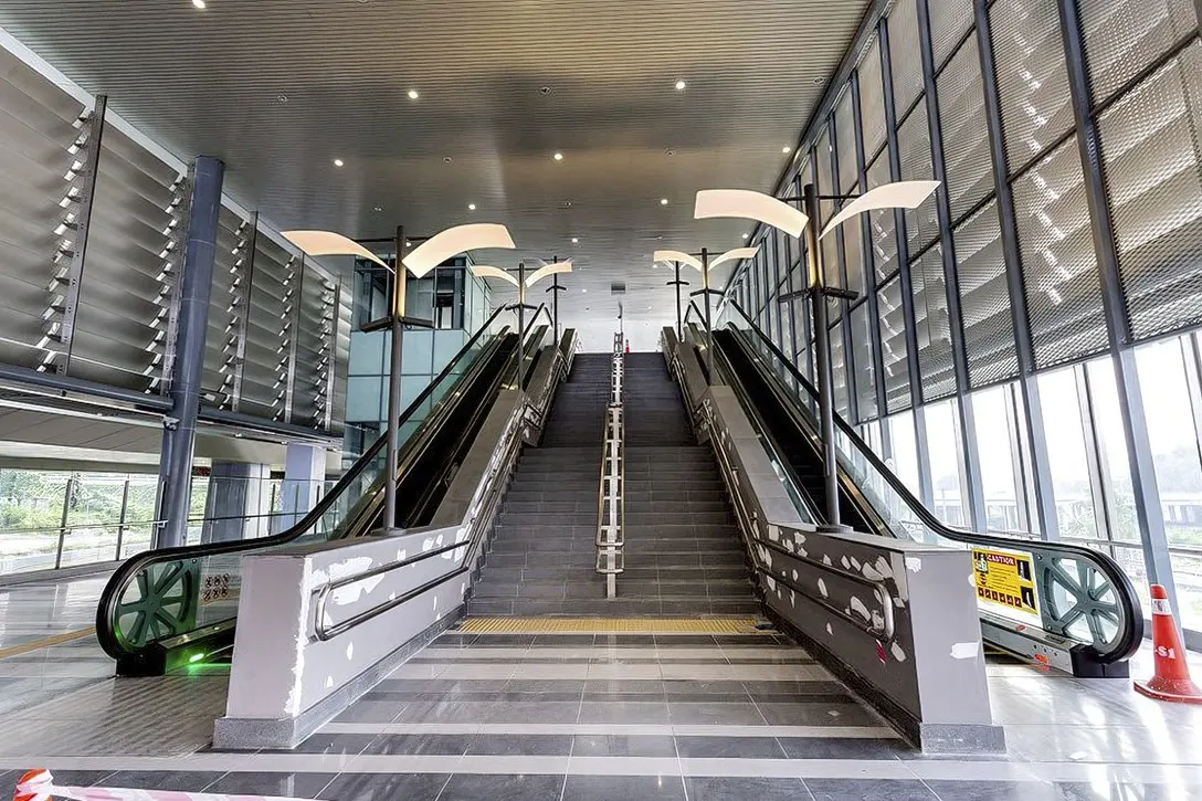 The escalators and stairs at the concourse level of the Sungai Buloh Station.