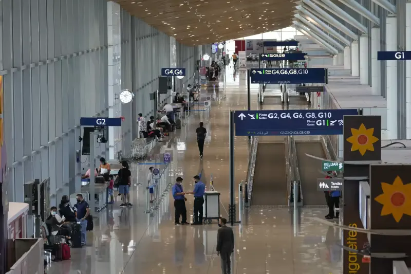 Travelers are seen waiting for flights at Kuala Lumpur International Airport in Sepang, Malaysia, Friday, April 1, 2022. 