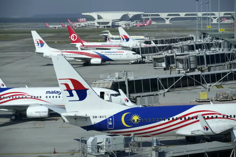 Malaysia Airlines planes taxi at terminal while uploading passengers at Kuala Lumpur International Airport in Sepang, Malaysia, Friday, April 1, 2022. 