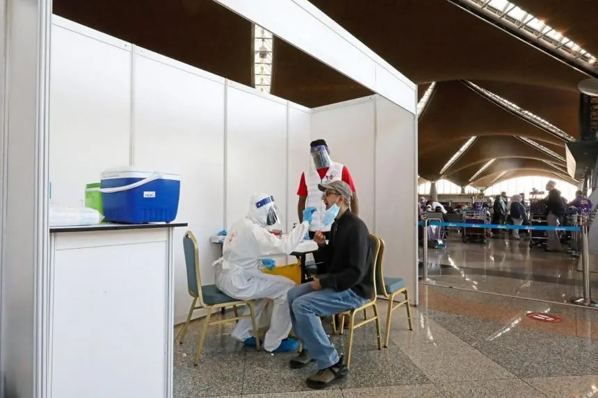 A health worker carrying out a Covid-19 test at Kuala Lumpur International Airport. PHOTO: THE STAR/ASIA NEWS NETWORK