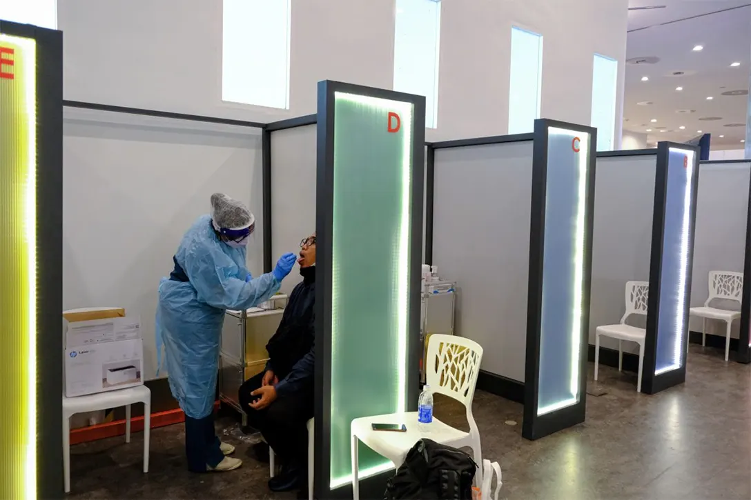 Opened borders: A health worker administering a test at a Covid-19 screening centre at KLIA2. Malaysia began to allow quarantine-free entry for fully vaccinated travellers from April 1. – Bloomberg