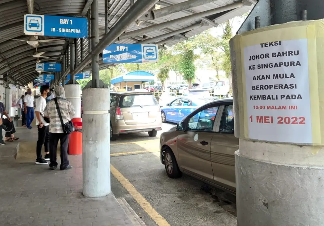A poster informing the public that cross-border taxi services between Johor Baru and Singapore have resume at Larkin Sentral Bus Terminal here in Johor Baru on May 1.