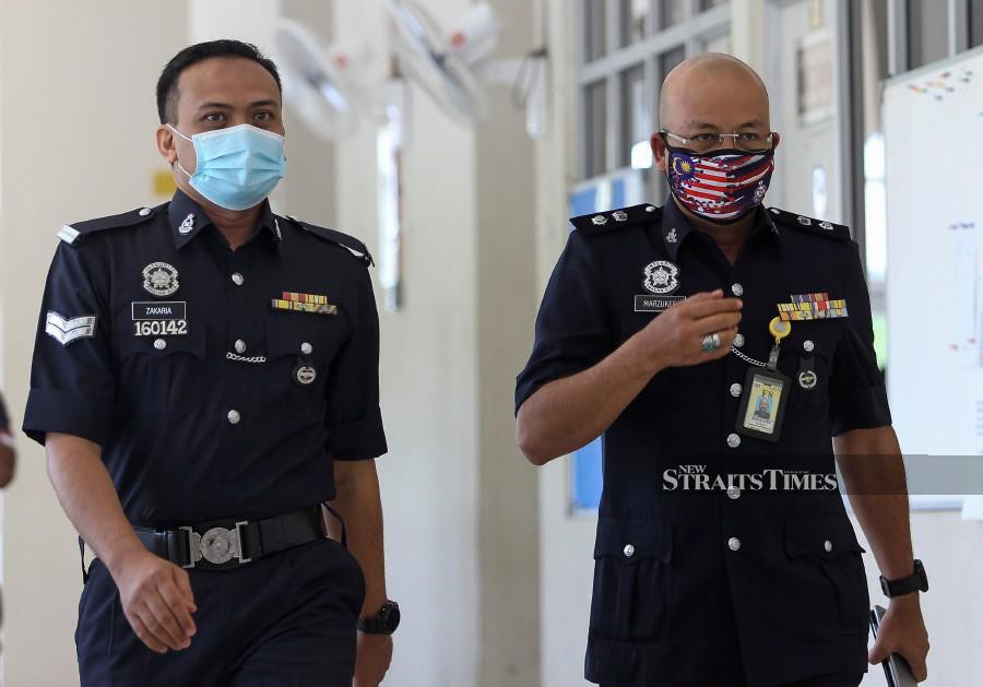 Nilai district police chief Superintendent Mohd Nor Marzukee Besar (right) arrives at the court ahead of the trial. -NSTP/AZRUL EDHAM MOHD AMINUDDIN