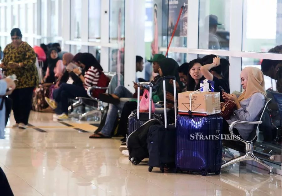 Passengers waiting for their buses as they start their balik kampung journey at the Terminal Bersepadu Selatan (TBS) in Kuala Lumpur.