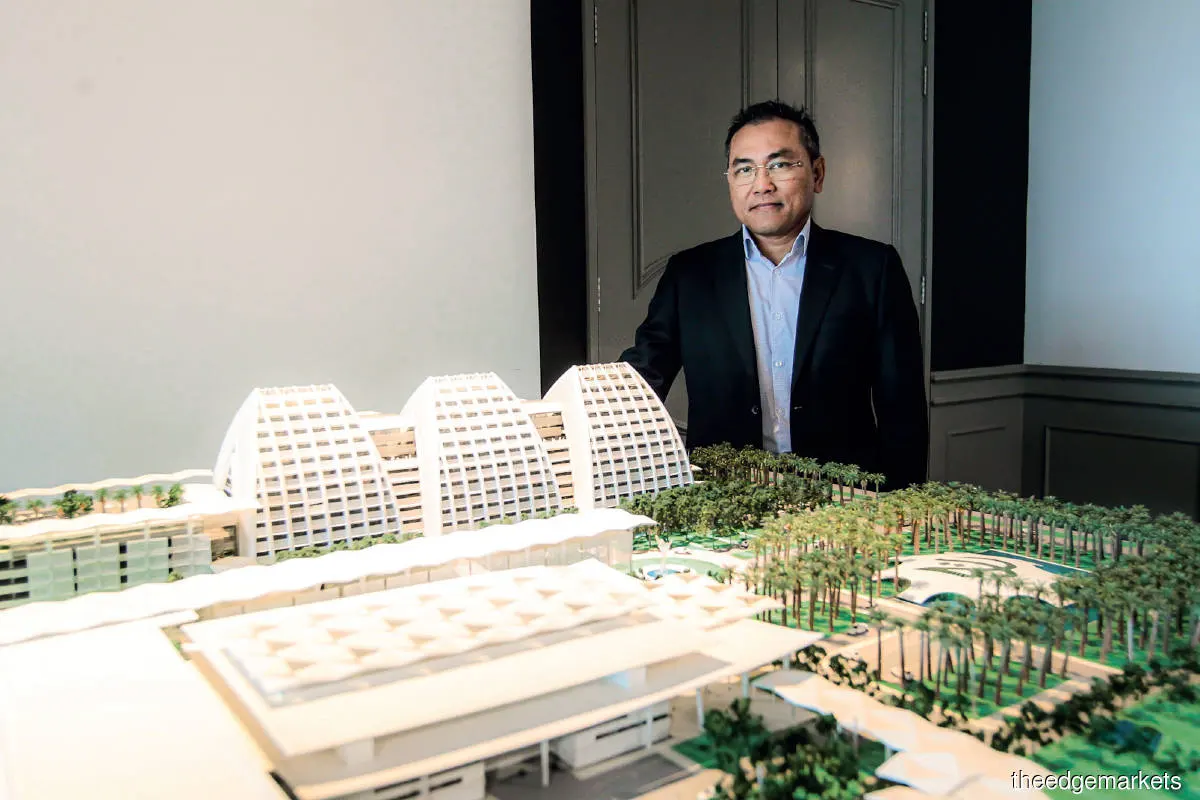 Azman (with a model of TH Properties’ Mövenpick Hotel and Convention Centre KLIA): Our upcoming project, Pristine Premier, will be the last one in our Pristine collection (Photo by Zahid Izzani/The Edge)